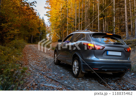 SUV on a Scenic Autumn Gravel Road SUV on a Scenic Autumn Gravel Road 118835462