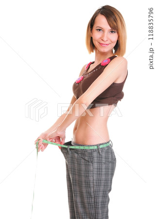 Pretty woman shows her weight loss wearing measure tapes isolated Pretty woman shows her weight loss wearing measure tapes isolated 118835796