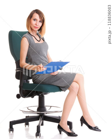 Full length business woman sitting on chair holding clipboard isolated Full length business woman sitting on chair holding clipboard isolated 118836083