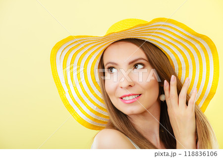 Woman in big yellow summer hat. 118836106