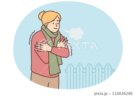 A woman freezes and stands in a room with a cold battery A woman freezes and stands in a room with a cold battery 118836286