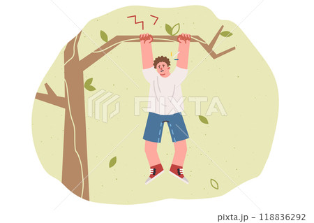 Teenage boy is at risk of falling from tree and getting injured, hanging on branch in need of help Teenage boy is at risk of falling from tree and getting injured, hanging on branch in need of help 118836292