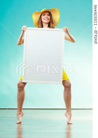 Woman in bikini holds blank presentation board. Woman in bikini holds blank presentation board. 118836446