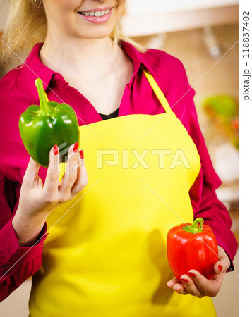 Woman holding bell peppers paprika Woman holding bell peppers paprika 118837402