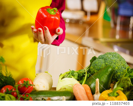 Woman holding bell peppers paprika Woman holding bell peppers paprika 118837403