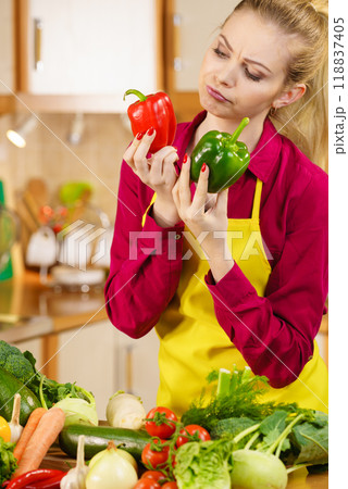 Woman holding bell peppers paprika thinking Woman holding bell peppers paprika thinking 118837405