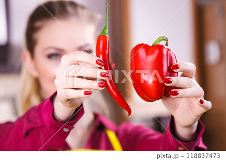 Woman holding bell pepper and chilli Woman holding bell pepper and chilli 118837473