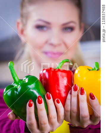 Woman holding bell peppers paprika 118837488