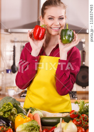 Woman holding two bell peppers Woman holding two bell peppers 118837493