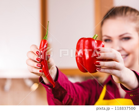 Woman holding bell pepper and chilli Woman holding bell pepper and chilli 118837500