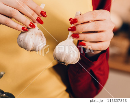 Woman holding two garlic Woman holding two garlic 118837858