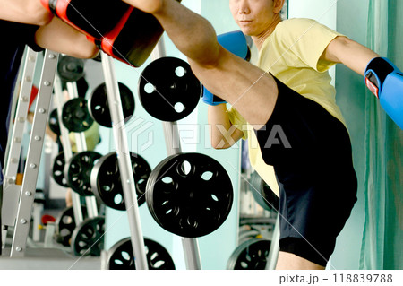 キックを打つ男性とミットを持つトレーナー キックを打つ男性とミットを持つトレーナー 118839788