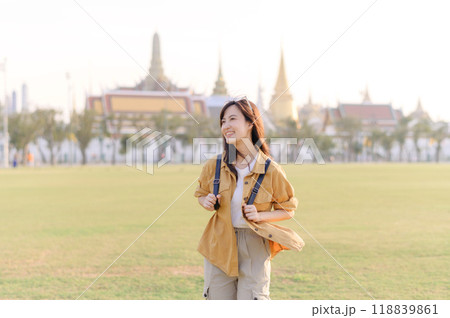 A Traveler Asian woman in her 30s exploring Wat Pra Kaew. From stunning architecture to friendly locals, she cherishes every moment, capturing it all in her heart and camera for years to come. 118839861
