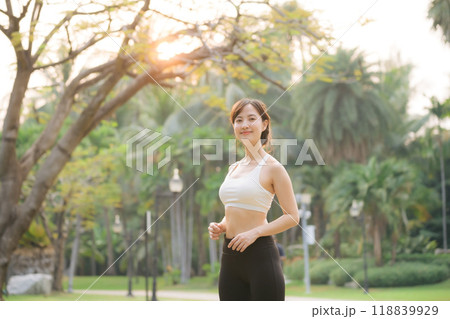 sportswoman with white sportswear in public park. 118839929