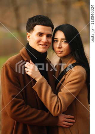Young couple in love walking in the park on a autumn day. Enjoying time together. Young couple in love walking in the park on a autumn day. Enjoying time together. 118840324