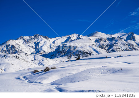 Winter landscape with mountains covered snow under blue sky in cold sunny day 118841838