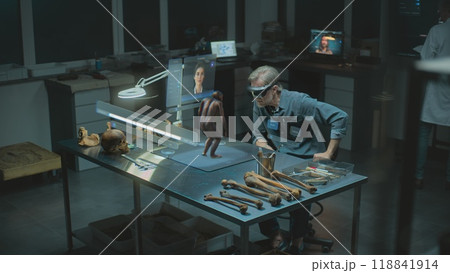 Archaeologist in VR headset studies human evolution in virtual AI simulator Archaeologist in VR headset studies human evolution in virtual AI simulator 118841914