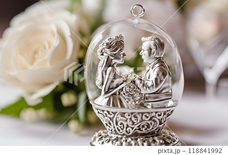 Beautiful glass crystal encases a joyful bride and groom doll holding hands, symbolizing love and happiness, making it a charming and elegant wedding souvenir. AI Generated 118841992