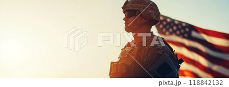 Silhouette of a US soldier against the sunset and flag, Veterans and Memorial Day celebration. 118842132