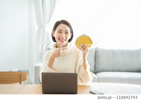 財布を持つ女性　笑顔　指差し 118842743