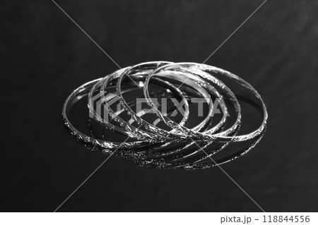 Bracelets. Women's jewelry on a dark background. Metal products. Fashion. 118844556