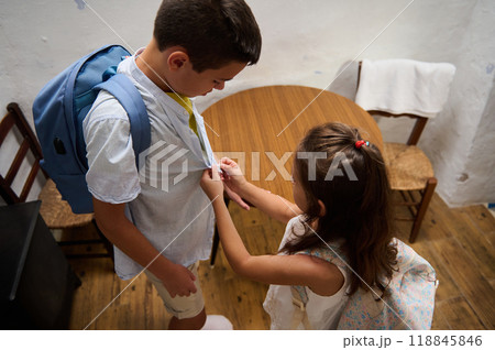 Young siblings helping each other get ready for school Young siblings helping each other get ready for school 118845846