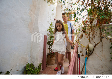 Children exploring a rustic garden with lush greenery Children exploring a rustic garden with lush greenery 118845847