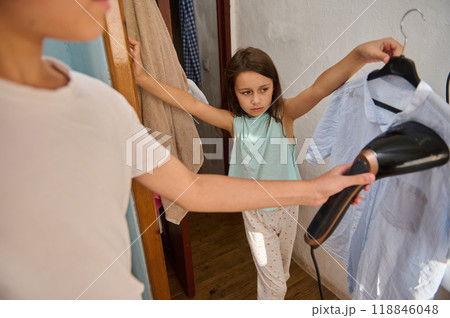 Children helping with ironing clothes at home 118846048