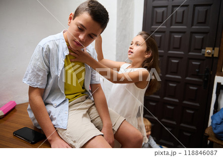 Children engaged in playful interaction indoors near doorway Children engaged in playful interaction indoors near doorway 118846087