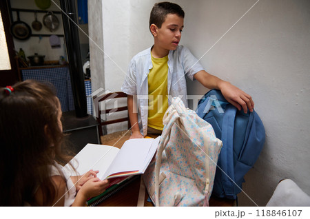Children preparing for school with backpacks and notebooks 118846107