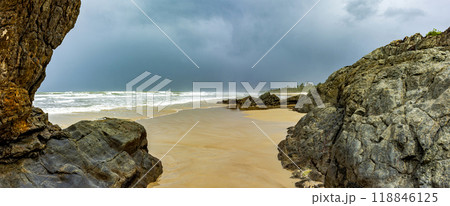 Dark rain clouds over beach 118846125