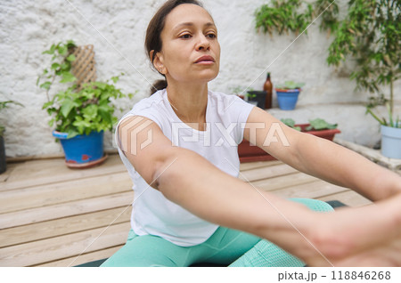 Focused woman practicing outdoor yoga in a peaceful garden setting, embracing mindfulness and relaxation Focused woman practicing outdoor yoga in a peaceful garden setting, embracing mindfulness and relaxation 118846268
