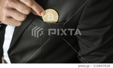 Businessman placing a Bitcoin in his pocket Businessman placing a Bitcoin in his pocket 118847026