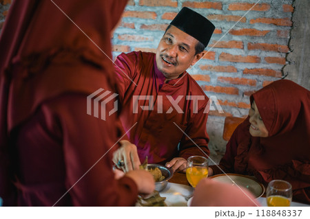 father and daughter and mother preparing a meal together 118848337