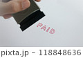 The Asian hand stamping rubber stamp with paid word, selective focus to paid word, white paper background. 118848636