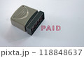 Close up Rubber stamp with paid word on white paper background. 118848637