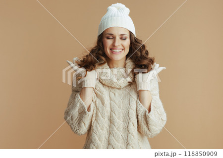happy stylish woman on beige background showing hair 118850909