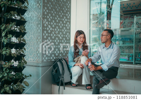 A Casual Conversation Taking Place Between Friends Inside a Modern Urban Setting A Casual Conversation Taking Place Between Friends Inside a Modern Urban Setting 118851081