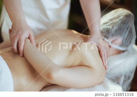medical massage therapist massaging clients back 118851318