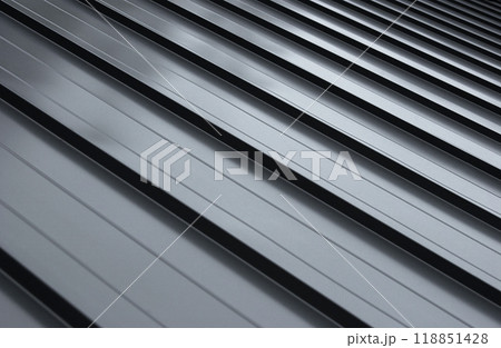 Close-up house retro roof panel with standing seam and fasteners. Modern galvanized steel roofing sheet with ribs. Classic style black metal panel with rebate joint. Falz roofing. Building's covering 118851428