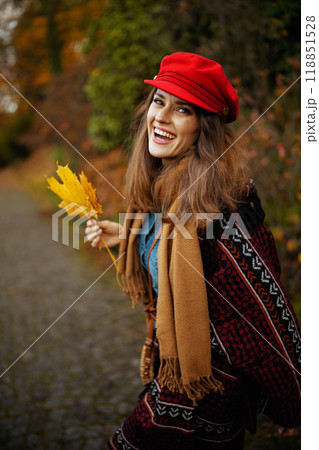 smiling modern 40 years old woman in red hat walking smiling modern 40 years old woman in red hat walking 118851528