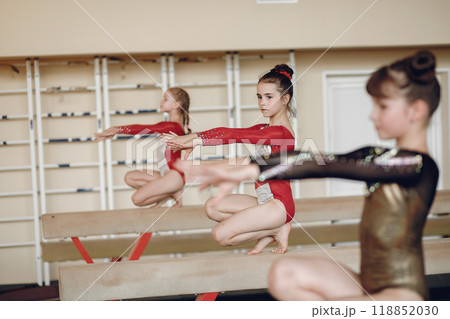Rhythmic gymnastics. Girls gymnasts, performs various gymnastic exercises and jumping. Childs and sport, a healthy lifestyle. 118852030