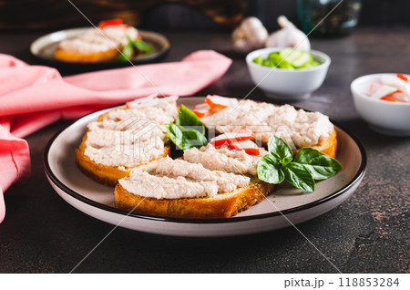 Crab stick and cucumber pate on toast on a plate on the table 118853284