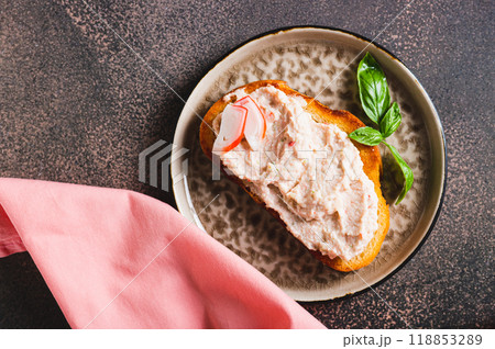 Close up os crab stick and cucumber pate on toast on a plate on the table vertical view 118853289