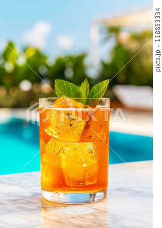 Glass with cocktail Aperol Spritz on the background of a hotel pool, vertical poster 118853334