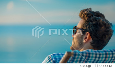 Poster with a young bearded man in a sun lounger against the background of the beautiful Mediterranean sea, vacation advertising concept 118853348