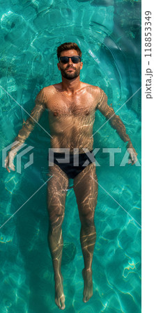 Vertical poster with a man lying on the water in a swimming pool, view from a drone, resort vacation advertising concept 118853349