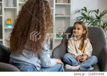 Long-haired female speech therapist having a session with a girl 118854506