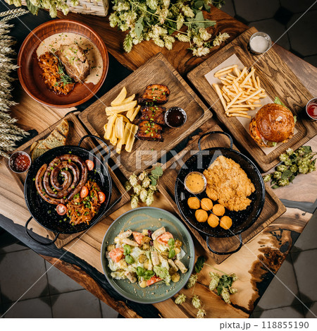 Top view of assorted gourmet dishes with sausage, pork ribs, salad, schnitzel, and burger with fries Top view of assorted gourmet dishes with sausage, pork ribs, salad, schnitzel, and burger with fries 118855190