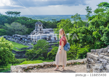 Female tourist exploring the ancient pyramids of Palenque, Mexico, surrounded by dense jungle. Cultural heritage and adventure travel concept Female tourist exploring the ancient pyramids of Palenque, Mexico, surrounded by dense jungle. Cultural heritage and adventure travel concept 118855430